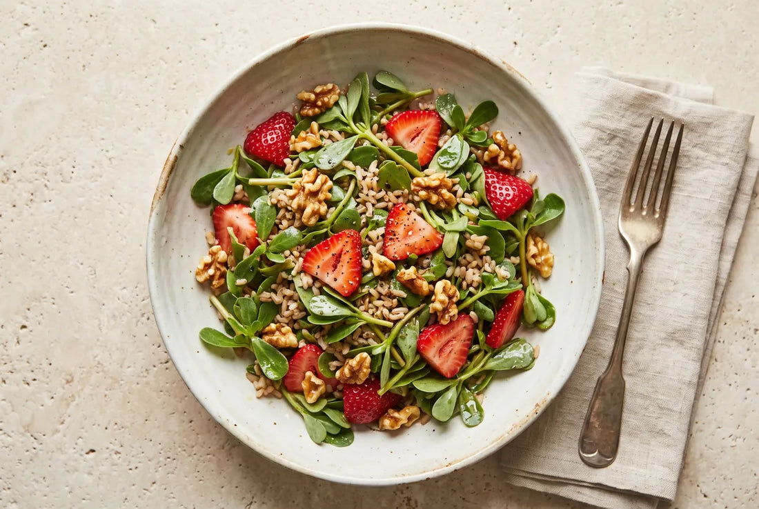 Purslane salad with brown rice, strawberries and walnuts in a lemony olive-oil dressing.