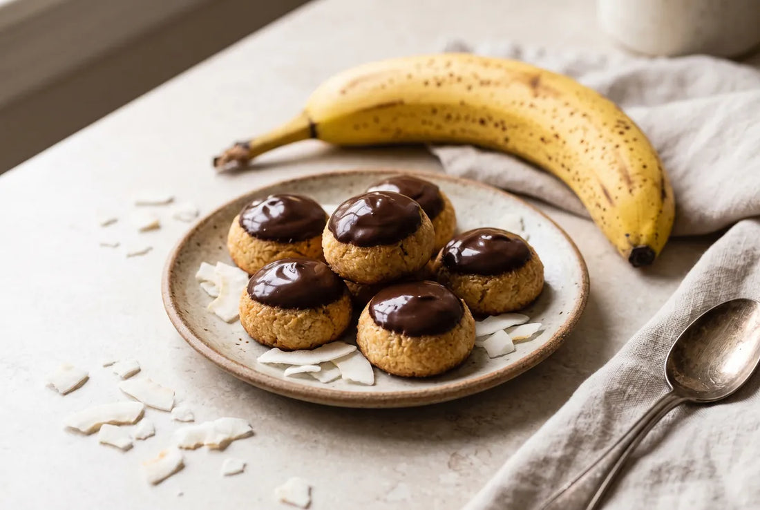 Three-ingredient banana-coconut cookies capped with melted dark chocolate.