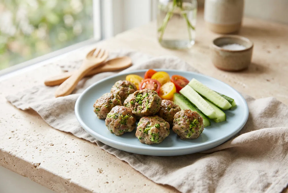 Soft baked broccoli and beef meatballs with curd cheese, made for toddlers.